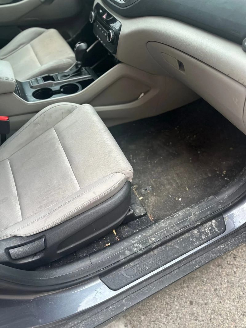 Interior of a dirty car showing unclean seats and floor