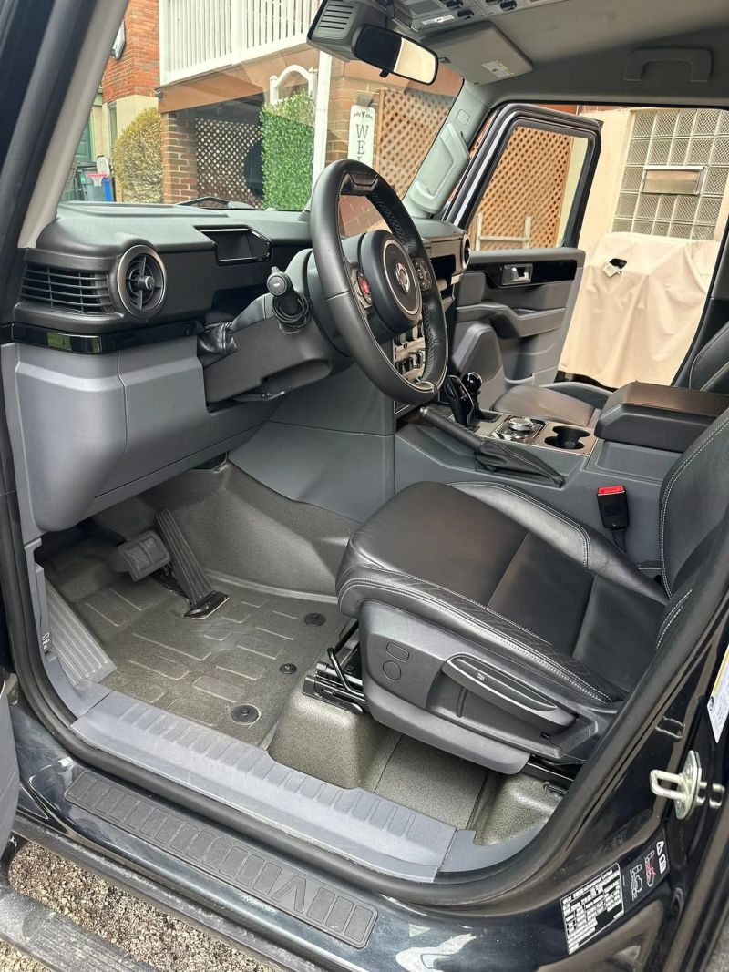 Interior of a meticulously detailed vehicle showing clean seats and dashboard.
